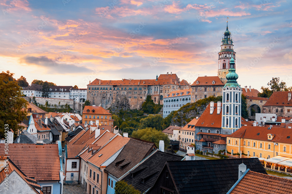 The view of the Český Krumlov castle and the town of Cesky Krumlov at sunrise. Beautiful colorful clouds. South Bohemia, Czech Republic. 