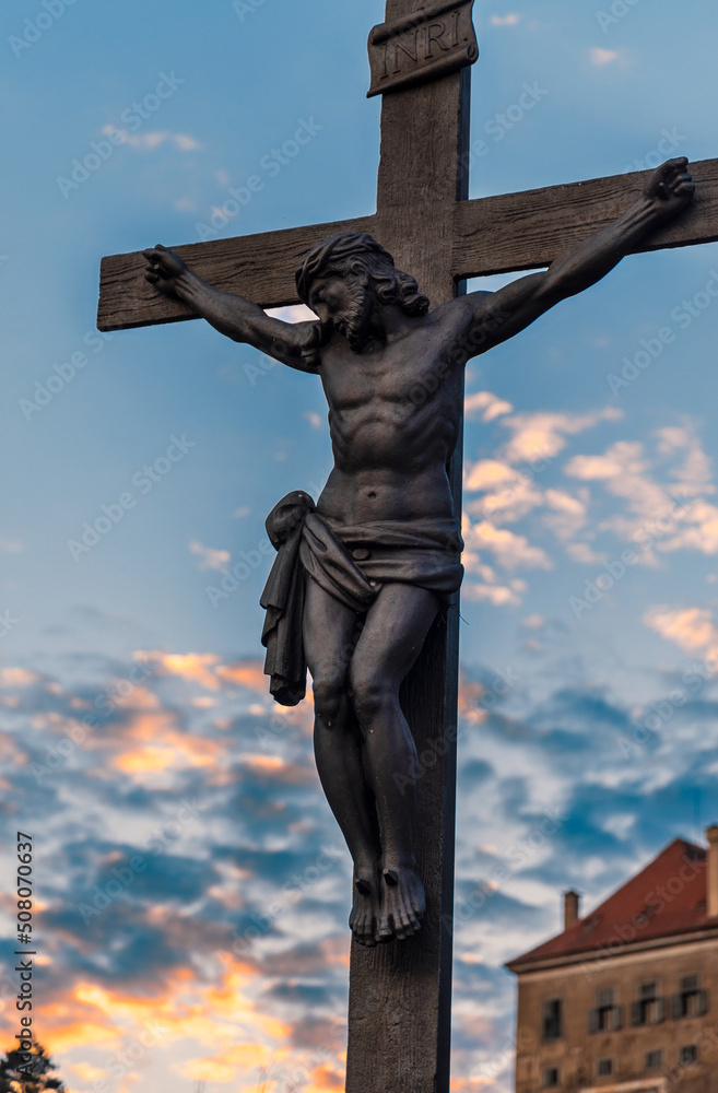 Crucifix near Cesky Krumlov castle. The statue of the crucified Jesus Christ on the cross on the Lazebnicky bridge in Cesky Krumlov, Czech Republic. Crucifix near Cesky Krumlov castle. The statue of the crucified Jesus Christ on the cross on the Lazebnicky bridge in Cesky Krumlov, Czech Republic.