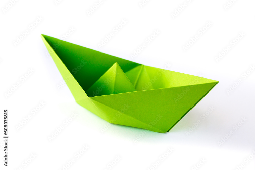Green paper boat origami isolated on a white background Green paper boat origami isolated on a white background