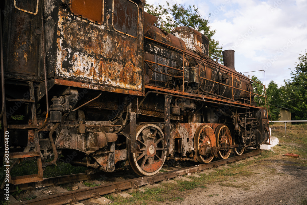 Burned-out locomotive is a museum exhibit at the railway station in the city of Trostyanets. Sumy region. Civil buildings. Russian military invasion of Ukraine. Burned-out locomotive is a museum exhibit at the railway station in the city of Trostyanets. Sumy region. Civil buildings. Russian military invasion of Ukraine.
