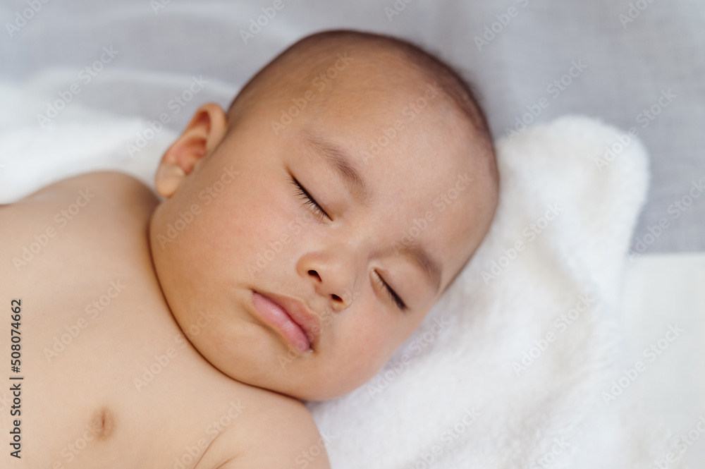 Asian Baby childhood infant sleeping on bed