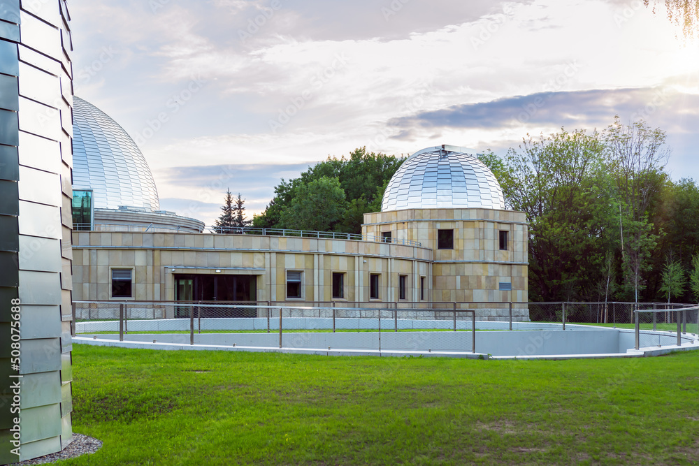Obraz premium Silesian planetarium after renovation. The dome of the Silesian planetarium shining in the light of the setting sun. Aluminum panels on the roof .