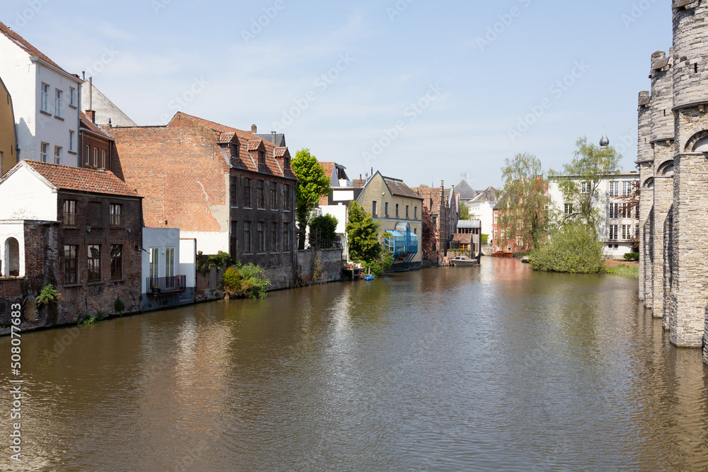 Naklejka premium View of Ghent historic center, castle Gravensteen, Leie river on a sunny day.