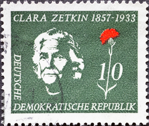 GERMANY, DDR - CIRCA 1957 a postage stamp from GERMANY, DDR, showing a portrait of KPD politician Clara Zetkin next to a red carnation. Circa 1957 photo