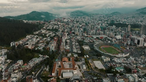 Aerial View Of Atahualpa Olympic Stadium And Downtown Quito In Ecuador  - drone shot photo