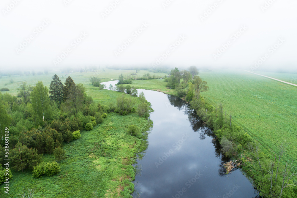 High angle view to a misty river landscape on a late spring morning in Estonia, Northern Europe