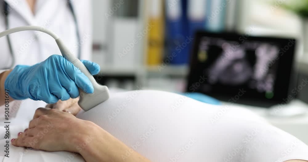 Pregnant woman undergoes ultrasound in clinic closeup Pregnant woman undergoes ultrasound in clinic closeup