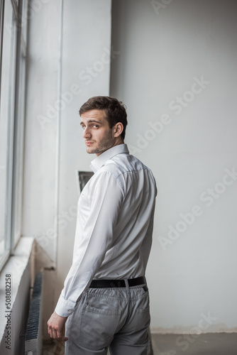 Georgian businessman standing against a white wall