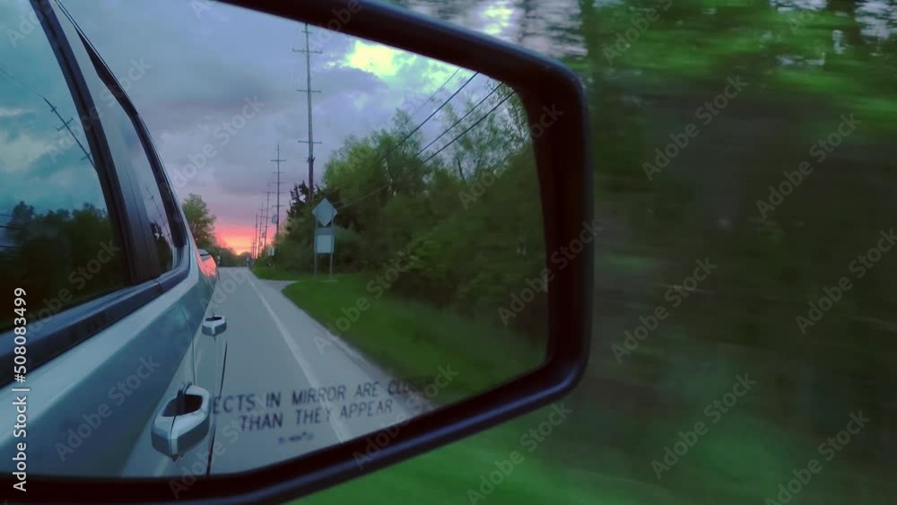 Reflection side rearview car mirror in morning on road at sunset or sunrise Reflection side rearview car mirror in morning on road at sunset or sunrise