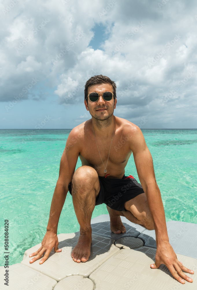 portrait of young hispanic man with sunglasses in Cozumel island Mexico