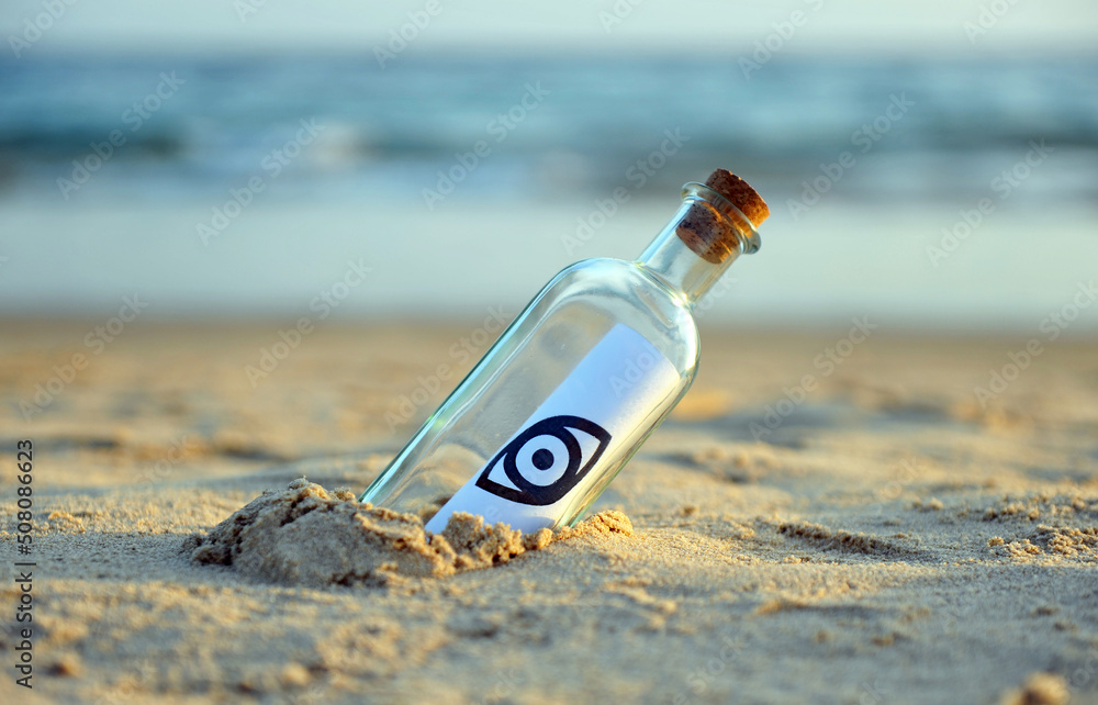 Eye symbol on a bottle found on the beach. Esoteric message. Lack of privacy concept icon. Eye symbol on a bottle found on the beach. Esoteric message. Lack of privacy concept icon.