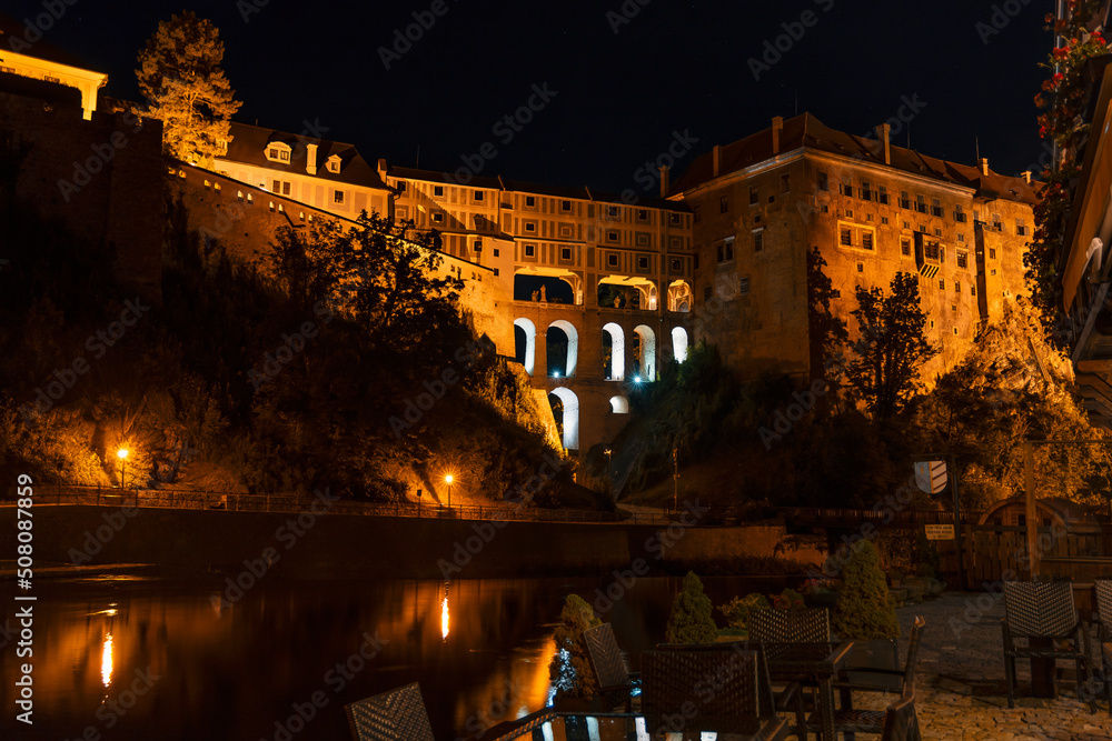 Night view of Cesky Krumlov Castle and the Cloak bridge from the banks of Vltava river. Spectacular renaissance and baroque chateau and castle in Cesky Krumlov, South Bohemia, Czech Republic. Night view of Cesky Krumlov Castle and the Cloak bridge from the banks of Vltava river. Spectacular renaissance and baroque chateau and castle in Cesky Krumlov, South Bohemia, Czech Republic.