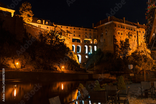 Night view of Cesky Krumlov Castle and the Cloak bridge from the banks of Vltava river. Spectacular renaissance and baroque chateau and castle in Cesky Krumlov, South Bohemia, Czech Republic.