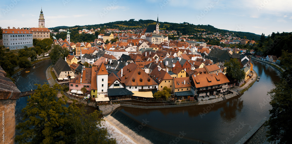Panoramatic view of the town of Cesky Krumlov, castle, St. Vitus church and Vltava river from the castle. Colorful picturesque old town houses. Český Krumlov, South Bohemia, Czech Republic.