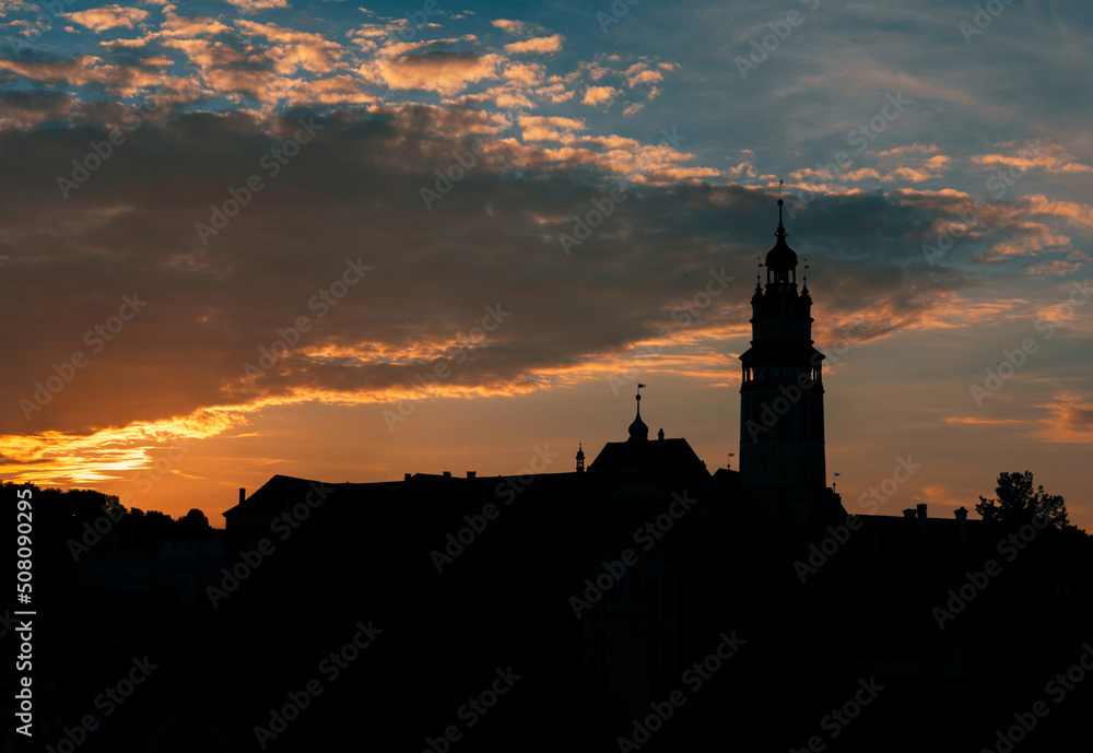 The silhouette of the Cesky Krumlov castle with beautiful colorful sky and clouds during sunset. Český Krumlov, South Bohemia, Czech Republic.