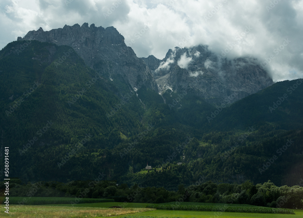 Fototapeta premium Church under the mountains. 