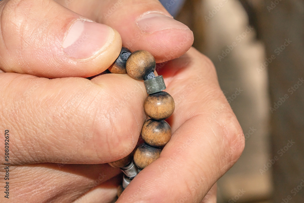 Old wooden prayer beads. Hold a religious attribute. Religious rosaries