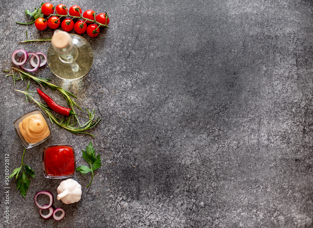 Gray stone background for cooking. Spices and vegetables. View from above. Free space for your text Gray stone background for cooking. Spices and vegetables. View from above. Free space for your text