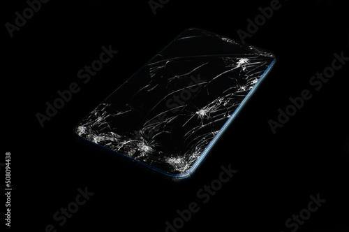 broken smartphone screen on black background