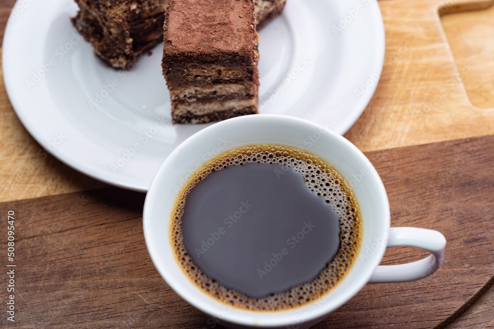 Uma xícara de café com palha italiana sobre superfície de madeira. Uma xícara de café com palha italiana sobre superfície de madeira.