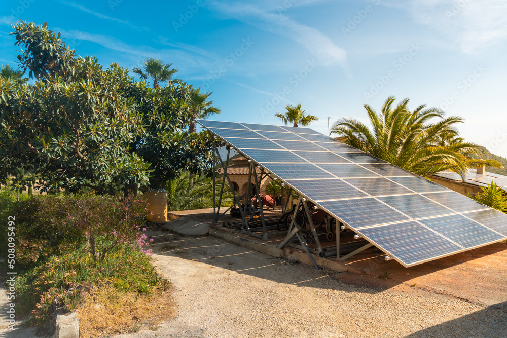 Solar panels installed outside a rural country house, in a natural environment, on a sunny day. Solar panels installed outside a rural country house, in a natural environment, on a sunny day.