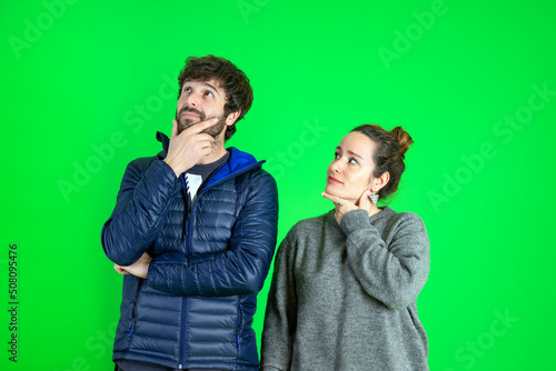 Photo of pensive hesitant man and woman look empty space hand chin