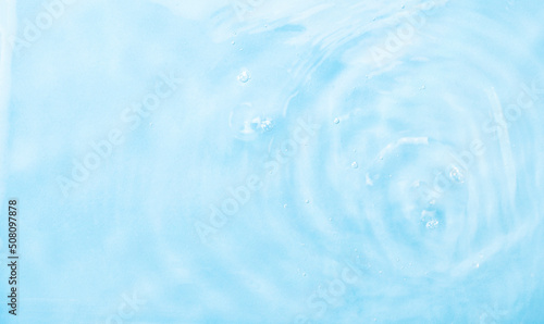 Blue water background. Summer blue wave. Abstract or natural background of beautiful wavy water texture. Defocus. The perfect backdrop for your presentation