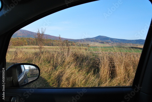 low, forested mountains, Ślęża mountain, Poland, seen from a car window