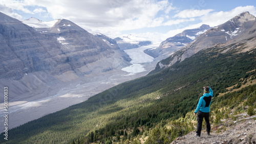 Male hiker enjoying the view on untouched alpine valley with glacier on its end, Jasper, Canada