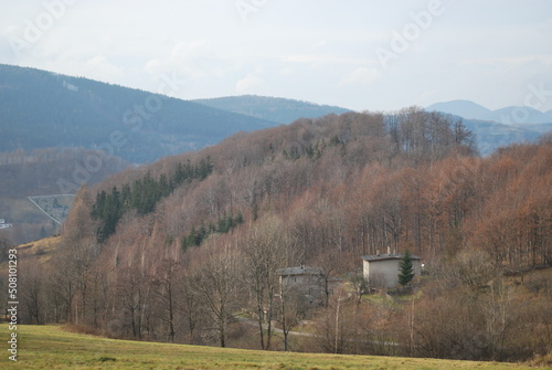 forested mountains and in the distance the town of Walim, Poland, Sowie Mountains, seen in the distance photo