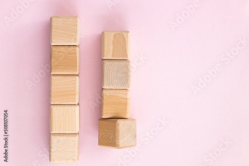 Fototapeta Naklejka Na Ścianę i Meble -  Wooden geometric shapes cubes isolated on a pink background