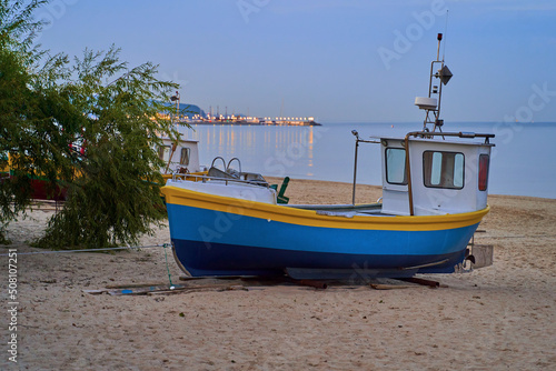 Obraz na płótnie Picturesque fishing boat on beach in Sopot, Pomorskie region, Poland w salonie