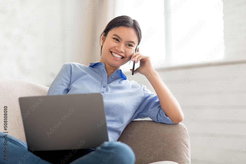 Cheerful korean lady freelancer working from home Cheerful korean lady freelancer working from home