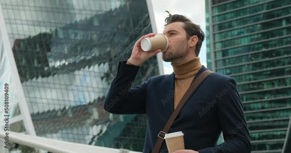businessman holding cup with beverage during coffee break. director of prosperous company enjoying cup of coffee in the morning. stylish man in a suit and turtleneck is waiting for a girl on a date businessman holding cup with beverage during coffee break. director of prosperous company enjoying cup of coffee in the morning. stylish man in a suit and turtleneck is waiting for a girl on a date