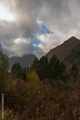 Autumn colour in Urkedalen, Møre og Romsdal, Norway, with the Sunnmore Alps beyond and a threatening sky above. photo