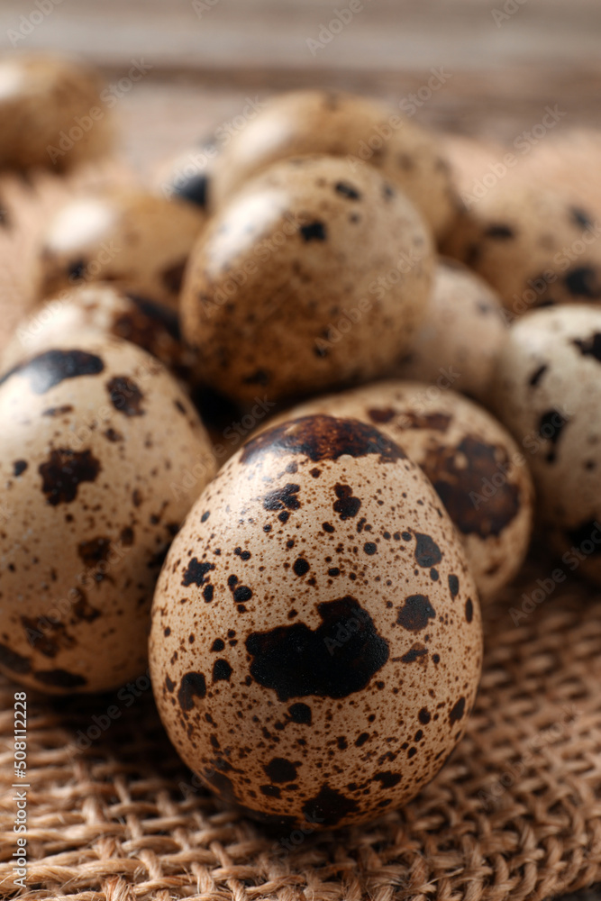 Fresh quail eggs on burlap fabric, closeup Fresh quail eggs on burlap fabric, closeup