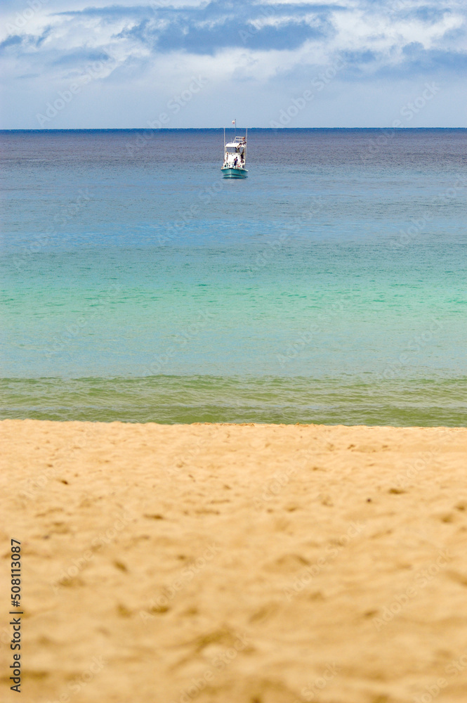Oahu Photograph - A fishing boat at the North Shore of Oahu without a wave or surfer in sight.