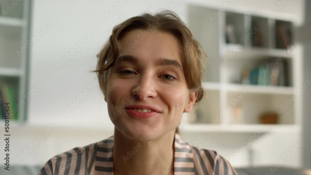 Beautiful blogger looking webcam at home closeup. Happy woman waving on call Beautiful blogger looking webcam at home closeup. Happy woman waving on call