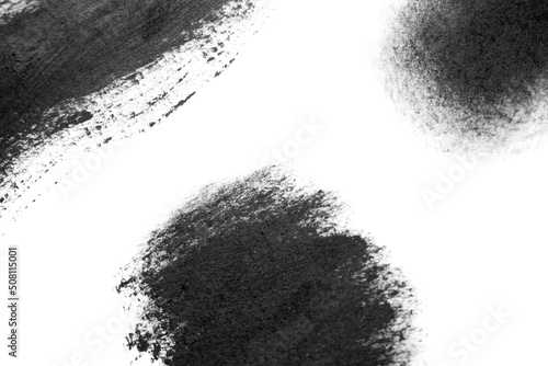 Black brush strokes oil paints on white paper. Isolated white background. Abstract art creative background. Space for text. Artist texture smears line painted brush black acrylic close-up. Copy space