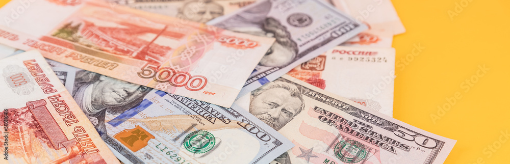 rubles lying on american dollars as a symbol of weakness russian national currency and strengthening of american dollar.financing of war and aggressive actions, no war and catastrophes.copy space rubles lying on american dollars as a symbol of weakness russian national currency and strengthening of american dollar.financing of war and aggressive actions, no war and catastrophes.copy space