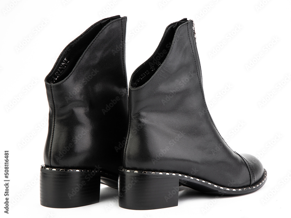 Women's autumn black leather jodhpur boots with zip and average heels, isolated white background. Back side view. Fashion shoes.