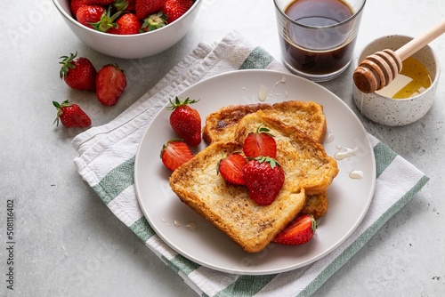 Homemade french cinnamon toast with strawberries, honey and coffee. Morning breakfast, brunch or lunch concept. Selective focus.