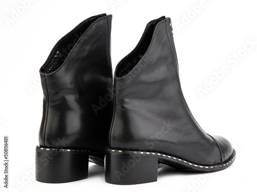Obraz na płótnie Women's autumn black leather jodhpur boots with zip and average heels, isolated white background. Back side view. Fashion shoes. w salonie