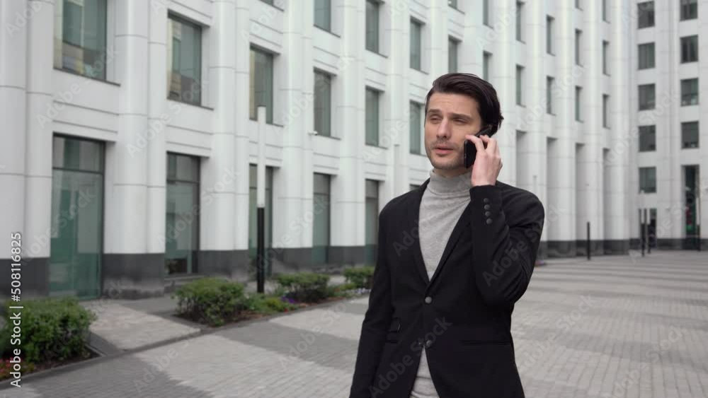 Handsome businessman leader executive boss talking with business partner on mobile phone. Busy business corporate concept on street downtown Handsome businessman leader executive boss talking with business partner on mobile phone. Busy business corporate concept on street downtown