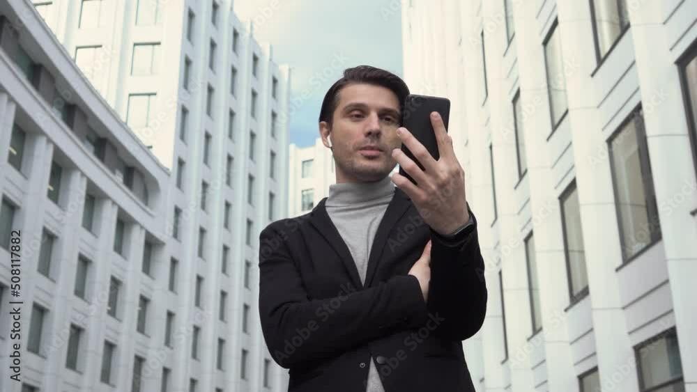 Handsome businessman leader executive boss talking with business partner on mobile phone. Video conference call concept