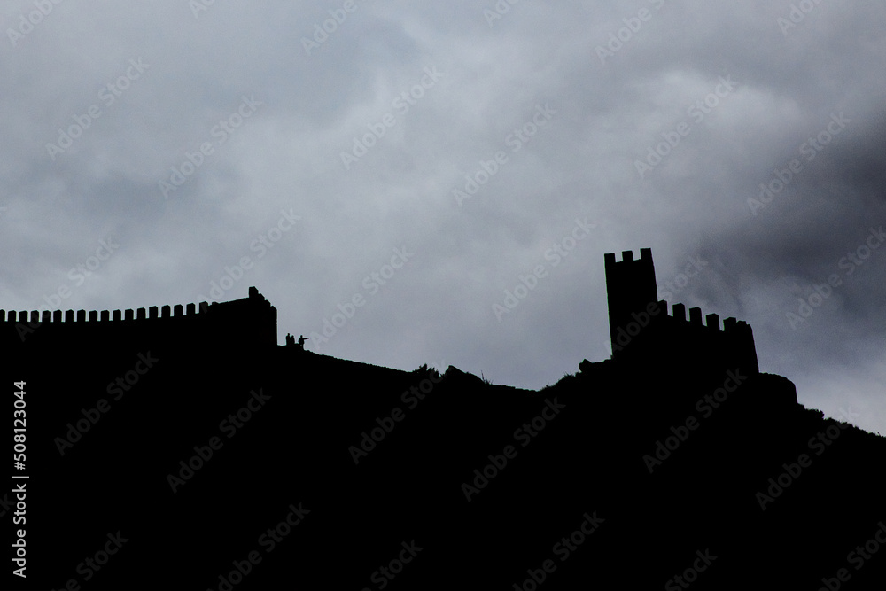 Silhouettes of people climbing the wall of Albarracín Silhouettes of people climbing the wall of Albarracín