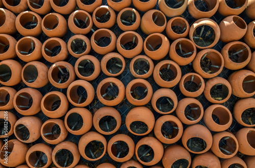 Close up of rows from the round clay pots. Element of design. Texture or background © Dmytro