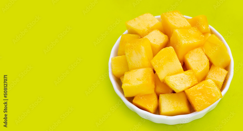 Yellow mango slices on green background. Yellow mango slices on green background.