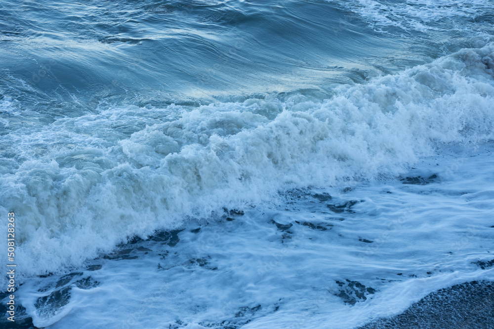 water texture with wave foam in the sea, background