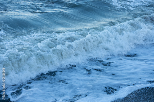 water texture with wave foam in the sea, background